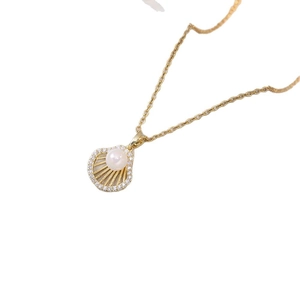 Elegant gold ginkgo leaf necklace with zircon-embellished shell and pearl pendant