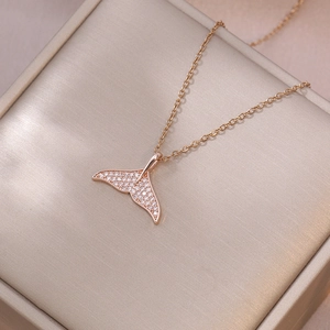 Elegant rose gold fishtail necklace with sparkling zircon crystals in a jewelry box