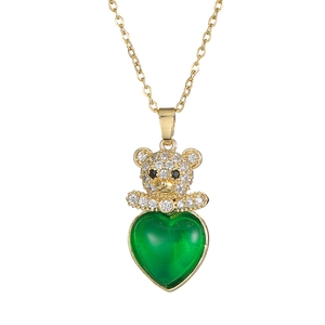 Golden bear necklace with emerald heart gemstone and zircon pavé on white background