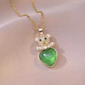 Gold titanium teddy bear necklace with emerald heart gemstone and pavé rhinestones