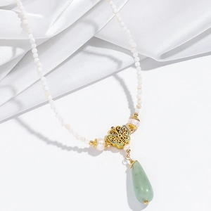 Detailed shot of Aventurine butterfly necklace with white pearls and green gemstone pendant
