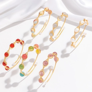 Handcrafted gold wire-wrapped open bangles featuring assorted pearls and crystals