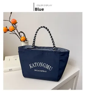 Detail view of water-repellent navy nylon tote bag with unique woven handles