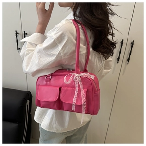 Hot pink shoulder bag with double pockets and a delicate white lace bow detail