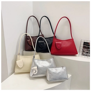 Close-up of stylish woven PU leather baguette bags in wine red, black and beige colors