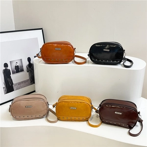 Minimalist crossbody bags with metal rivets and brand logo in various vintage colors