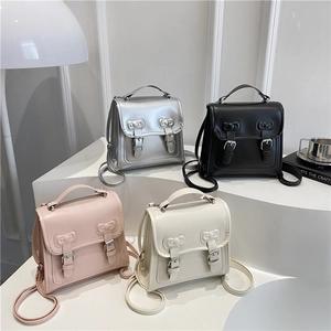 Mini bow-embossed backpack available in silver, black, pink, and beige faux leather