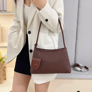 Minimalist deep brown woven shoulder bag for women with decorative circular charm pendant