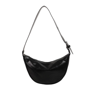 Minimalist black crescent shoulder bag in glossy PU leather with silver metal buckle detail