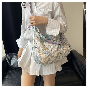 Floral canvas tote bag with purple checkered strap and adjustable green buckle detail