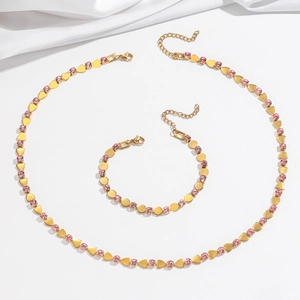 Golden titanium necklace and bracelet set with pink zircon hearts and lobster clasp