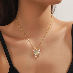 Close-up of golden bow-knot butterfly tassel necklace with pavé zircon settings