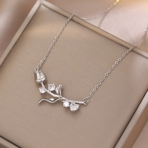 Elegant silver tulip pendant necklace with sparkling cubic zirconia on a gift box