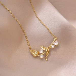 Elegant gold tulip bud and branch pendant necklace with sparkling clear zircon stones