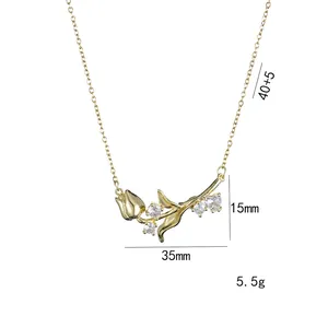 Elegant gold-tone tulip flower pendant necklace with white zircons on a white background