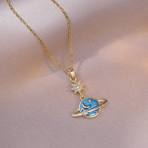 Golden necklace featuring a blue planet saturn pendant with sparkling zircon star accents