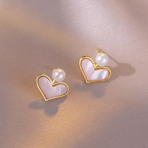 Elegant heart-shaped gold earrings with pink shell inlay and freshwater pearl on silk