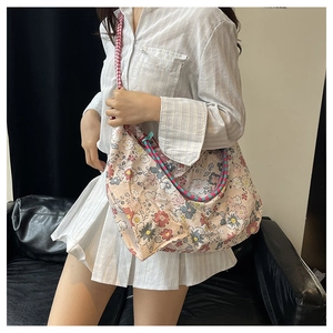 Detailed shot of floral canvas tote bag with unique red checkered and braided straps