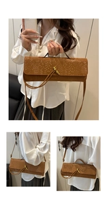 Details einer braunen Krokodil-Handtasche im Baguette-Stil mit goldenem Knotenverschluss