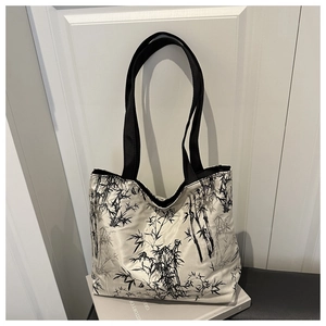 Detail of high-capacity tote bag with artistic bamboo ink print and black handles
