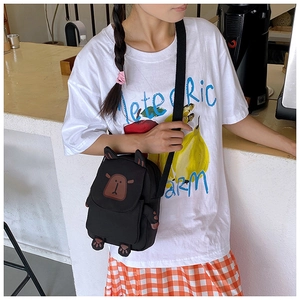 Detail of cute black canvas capybara crossbody bag with 3D ears and adjustable strap