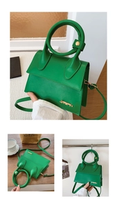 Detail of structured green crossbody bag with thick ring handle and gold JINGPIN logo
