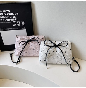 Detail of seersucker baguette bags featuring bow knots and rabbit polka dot patterns