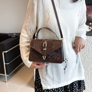 Brown faux leather crossbody handbag with snakeskin texture flap and gold buckle