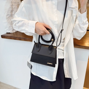 Elegant black faux leather handbag with round handle and adjustable strap for urban women