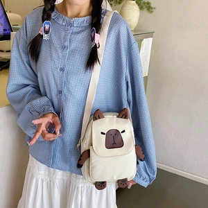 Cute cartoon capybara crossbody bag in off-white nylon with wide strap for summer