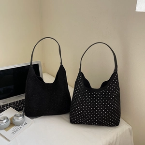 Minimalist black denim and rhinestone hobo underarm bags for women in a stylish setting