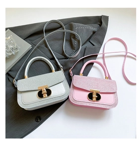 Close-up of glitter flap detail and gold T-lock on pink and silver mini handbags