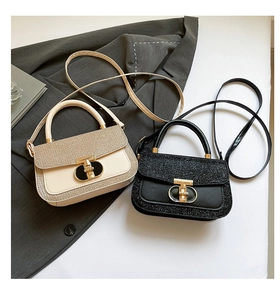 Detail of sequin and leather crossbody bags showing metal twist lock and texture