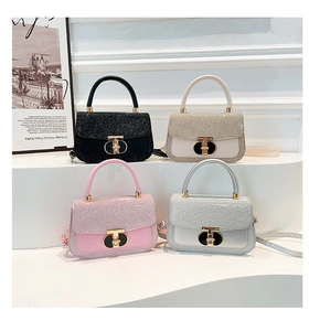 Mini handbags in black, gold, pink, and silver featuring glitter texture and metal locks