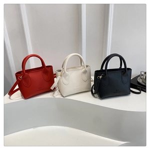 Minimalist litchi grain tote bags in red, white and black with delicate metal hardware