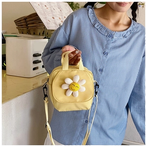Detail of yellow daisy canvas crossbody bag with 3D flower and adjustable straps