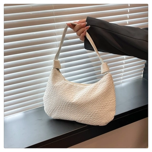 Macro detail of white woven texture on minimalist shoulder bag with smooth top zipper
