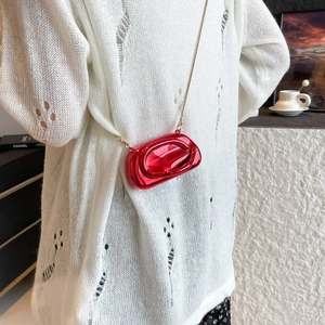 Red metallic acrylic mini crossbody bag with hollow D-letter design and gold chain strap