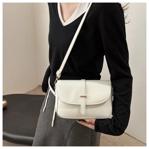 Detailed view of a white rectangular crossbody bag with golden metal buckle and thin strap
