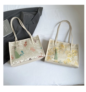 Detail of Chinese style jacquard tote bags featuring gold fish and floral embroidery