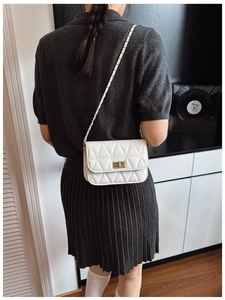 White quilted chain crossbody bag with diamond pattern and gold-tone twist lock