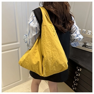 Detailed back view of a bright yellow canvas tote bag showing soft textured fabric drape