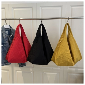 Detail of red black and yellow geometric tote bags in light nylon with side zippers