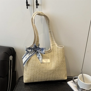 Chic beige straw tote bag with vertical stripes and blue floral silk scarf detail