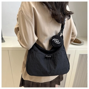 Detail of black nylon crossbody bag with mini ZME logo coin purse and drawstring design