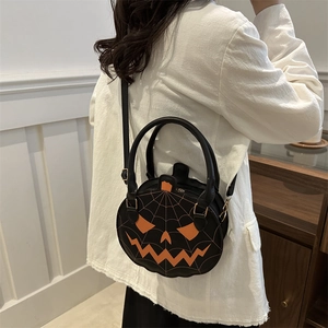 Halloween pumpkin crossbody bag in black matte leather with orange jack-o-lantern face