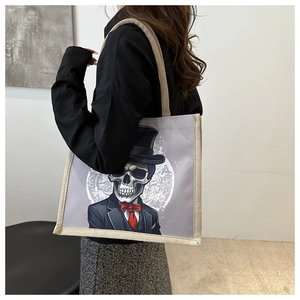 Canvas tote bag with skeleton gentleman print shown from a stylish side view angle