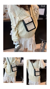 Détail du sac seau en toile avec bordure en cuir noir et fermoir métallique doré