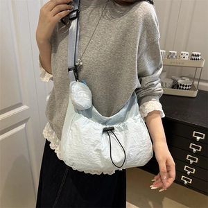 Light blue nylon dumpling bag with adjustable strap and small detachable round coin purse