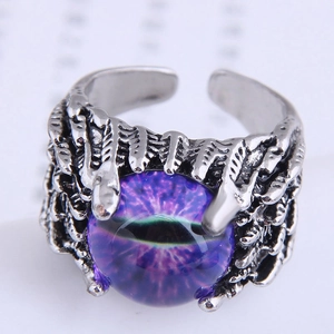 Detailed close-up of a gothic claw ring holding a mystical purple evil eye stone